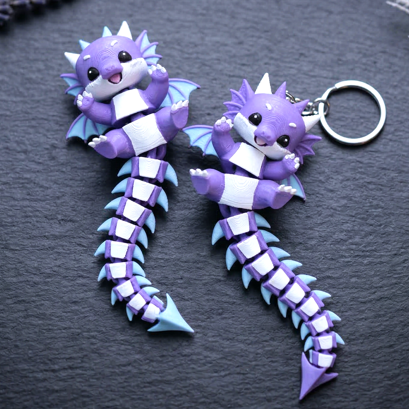 Cute flexi baby dragon keychain shown from a third angle