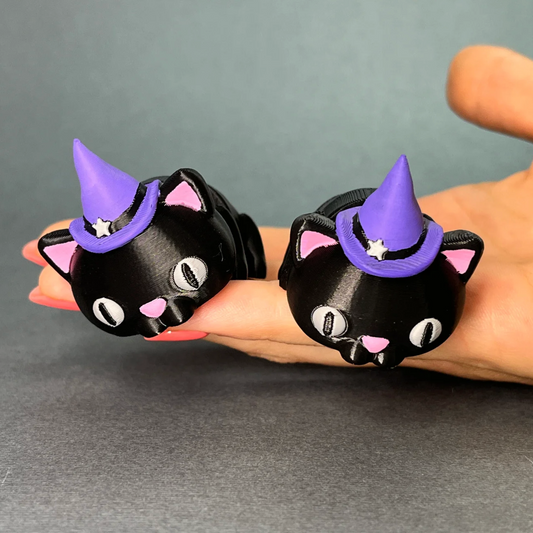 Flexi Halloween Cat keychains held in a hand